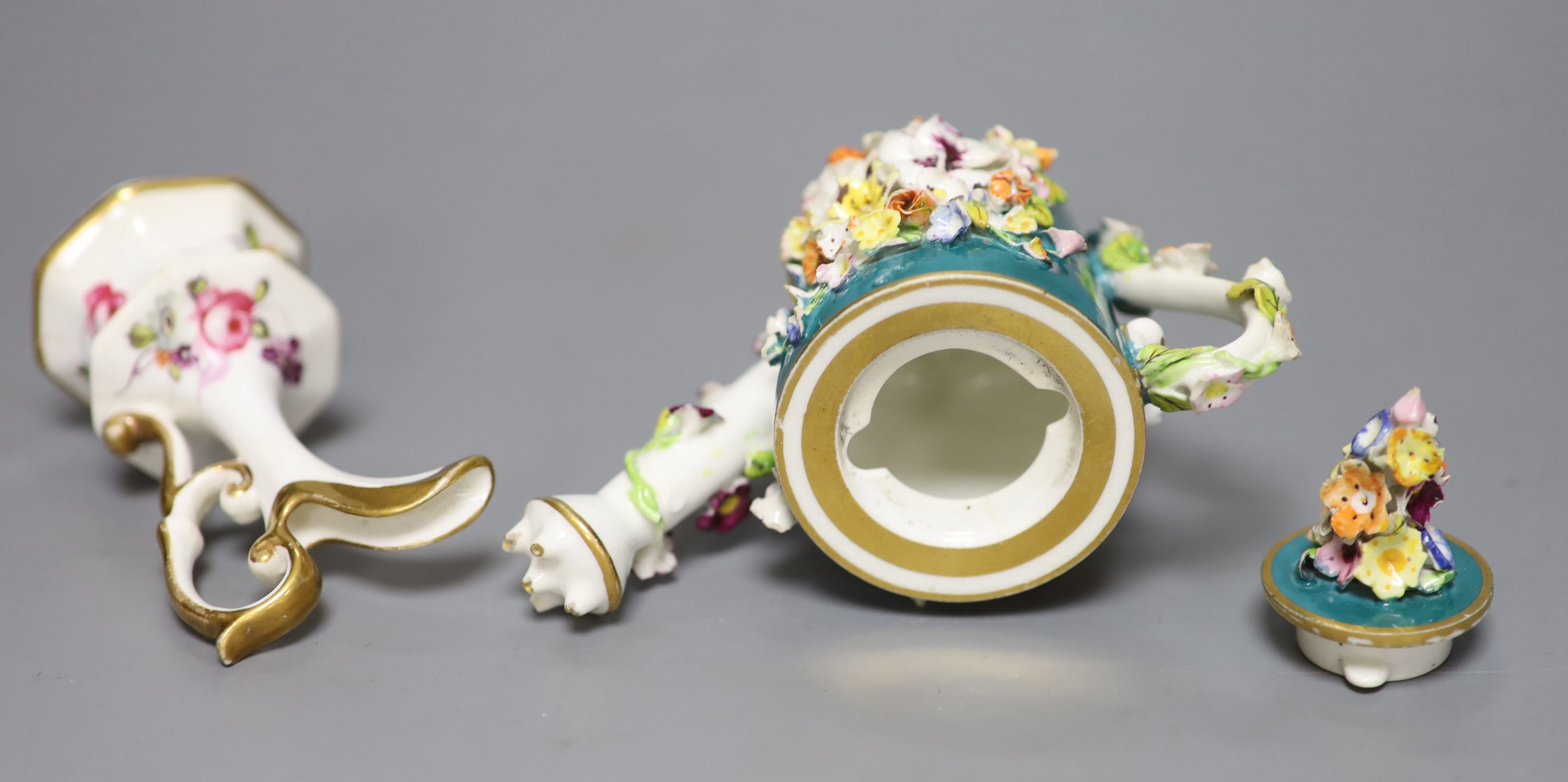 A 19th century Derby miniature water sprinkler and cover, encrusted with flowers on an avocado green ground, red crown D mark, 9cm and